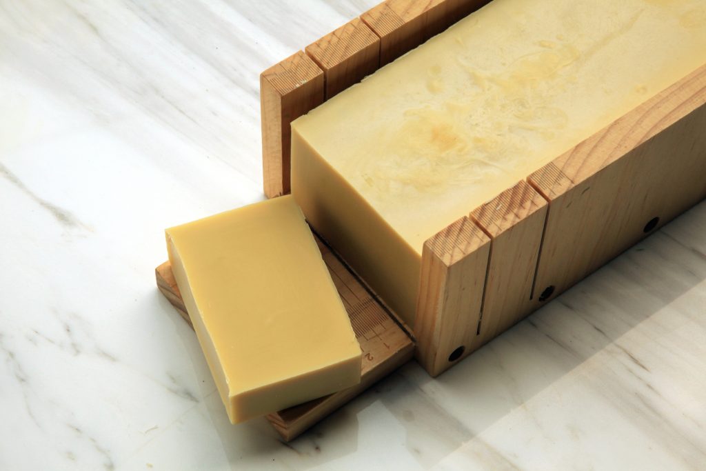 Handcrafted castille soap made with extra virgin olive oil displayed on marble backdrop